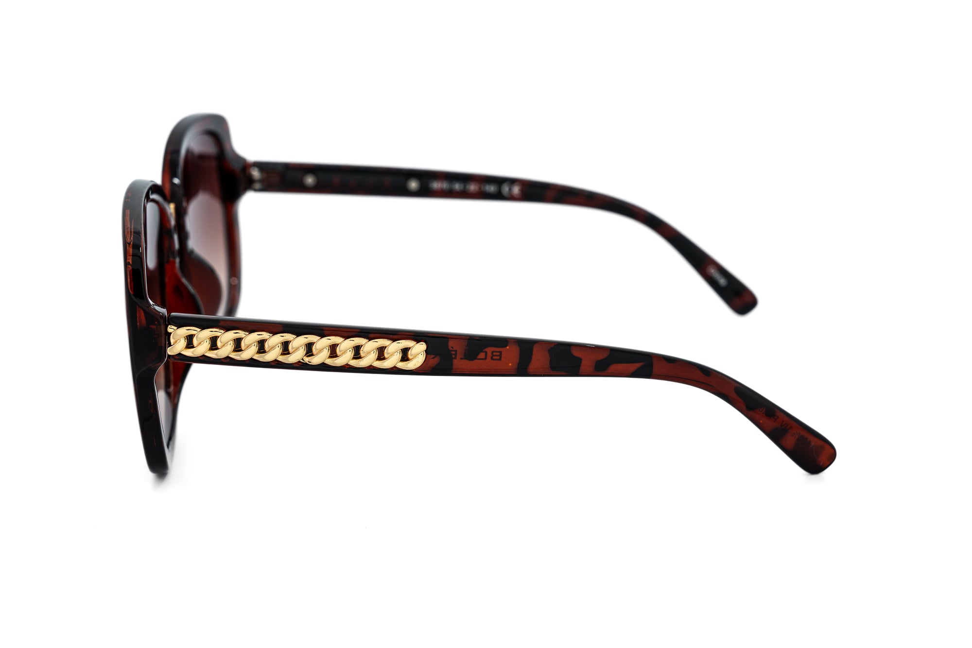 Calyra oversized tortoise sunglasses with gold chain-inspired temple detailing and brown gradient lenses side angle view
